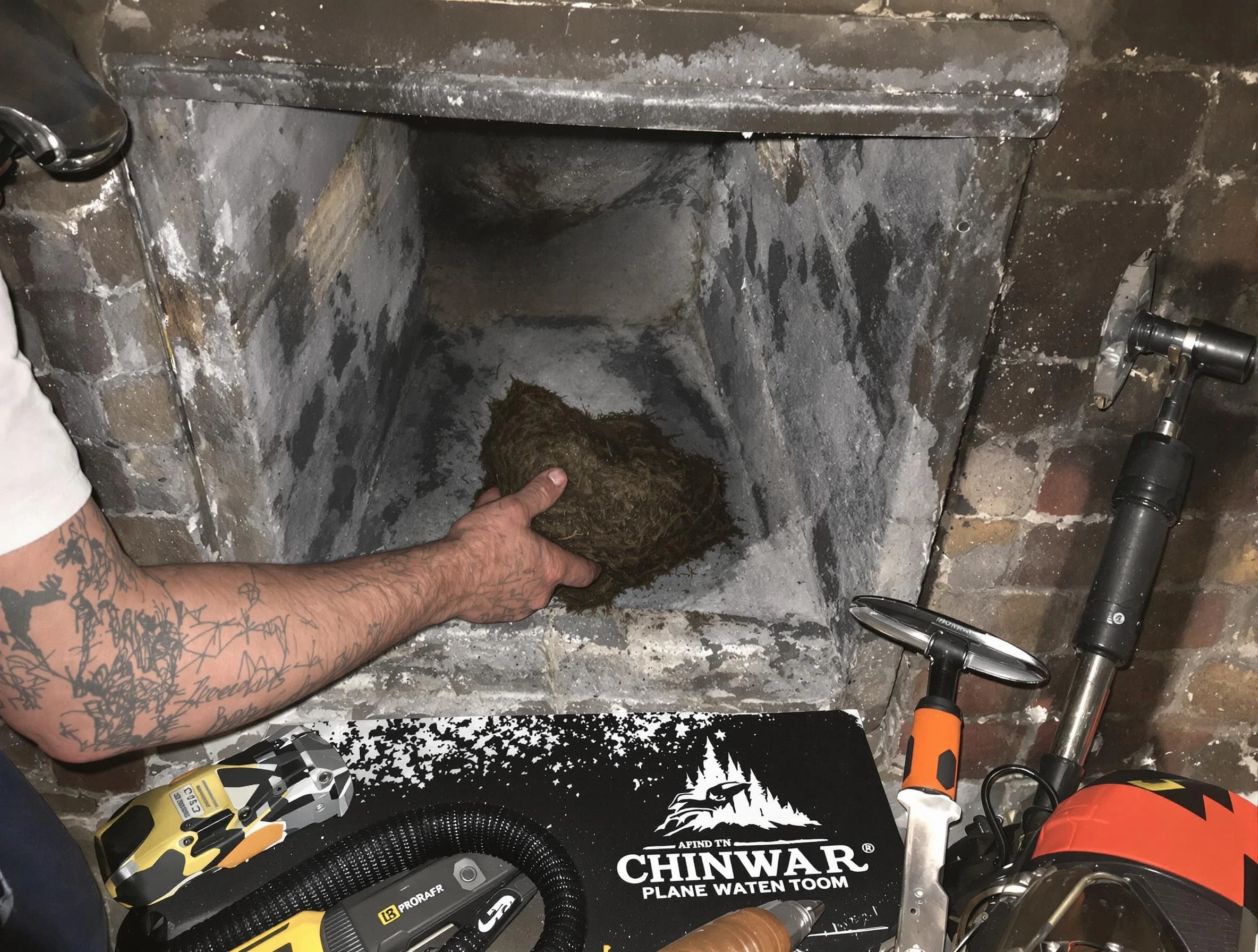 Billerica Chimney Sweep safely removing debris and screening chimney in Billerica, MA